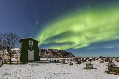 northern lights over the cemetery in fredvang, lofoten, norway