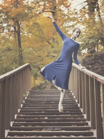 blue dressed ballerina girl is dancing in the nature