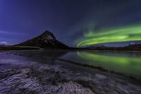 northern lights with reflections in lofoten, norway