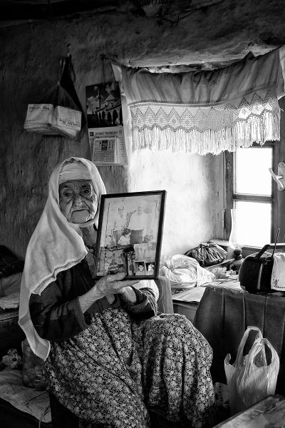 old woman shows her memories in the frame