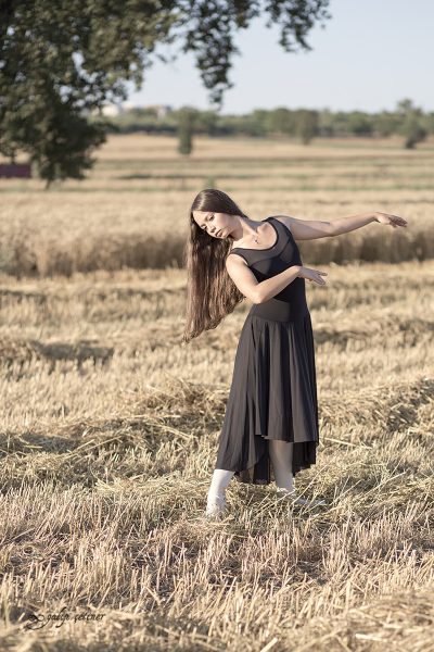 black dressed ballerina girl in the wheat field